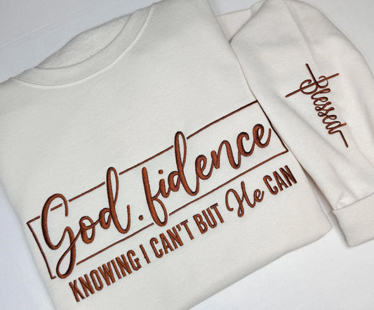 Cream embroidered Godfidence crewneck with brown chest design and coordinating sleeve embroidery